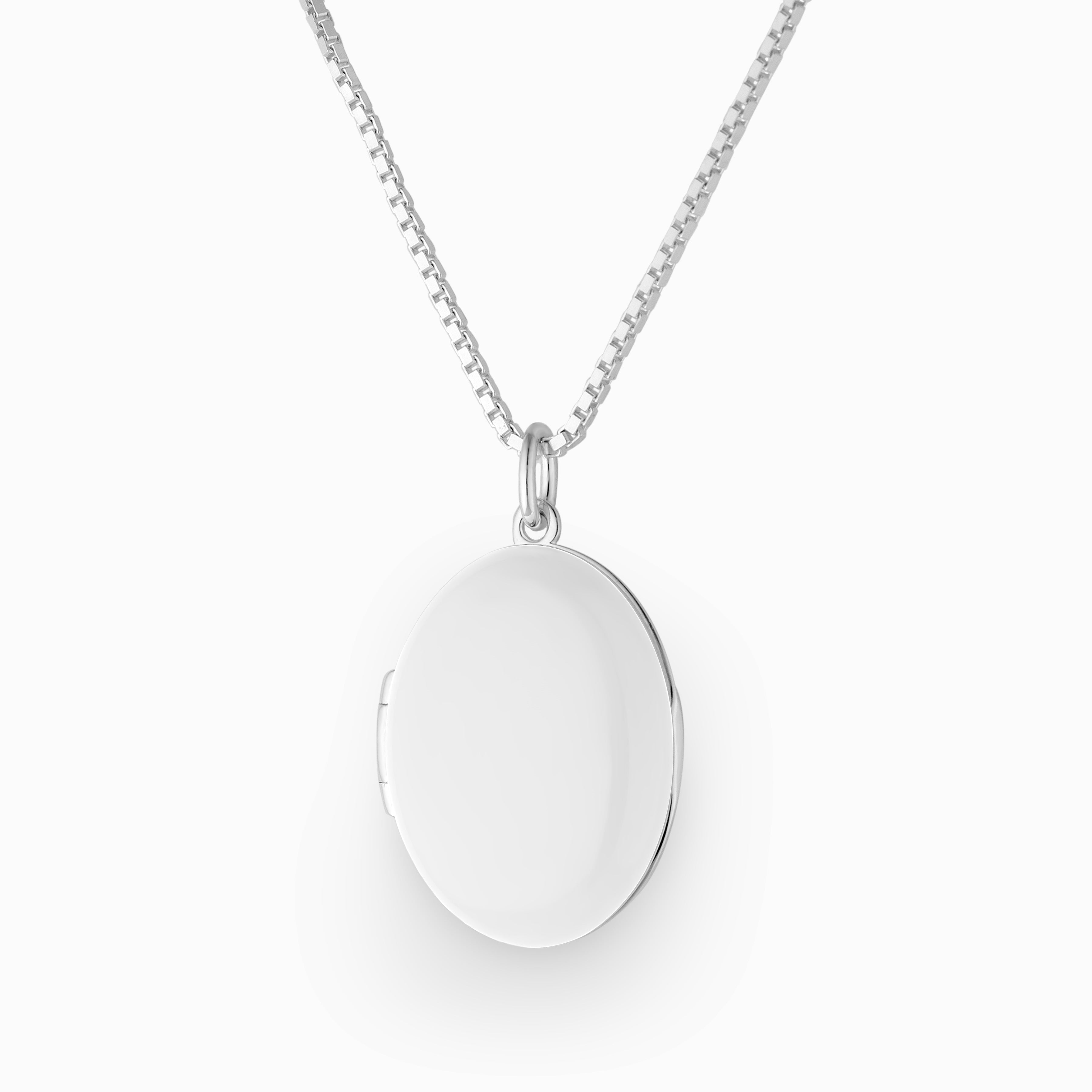 Photo of a 925 sterling silver oval locket enamelled in a high gloss white and placed on a box chain.