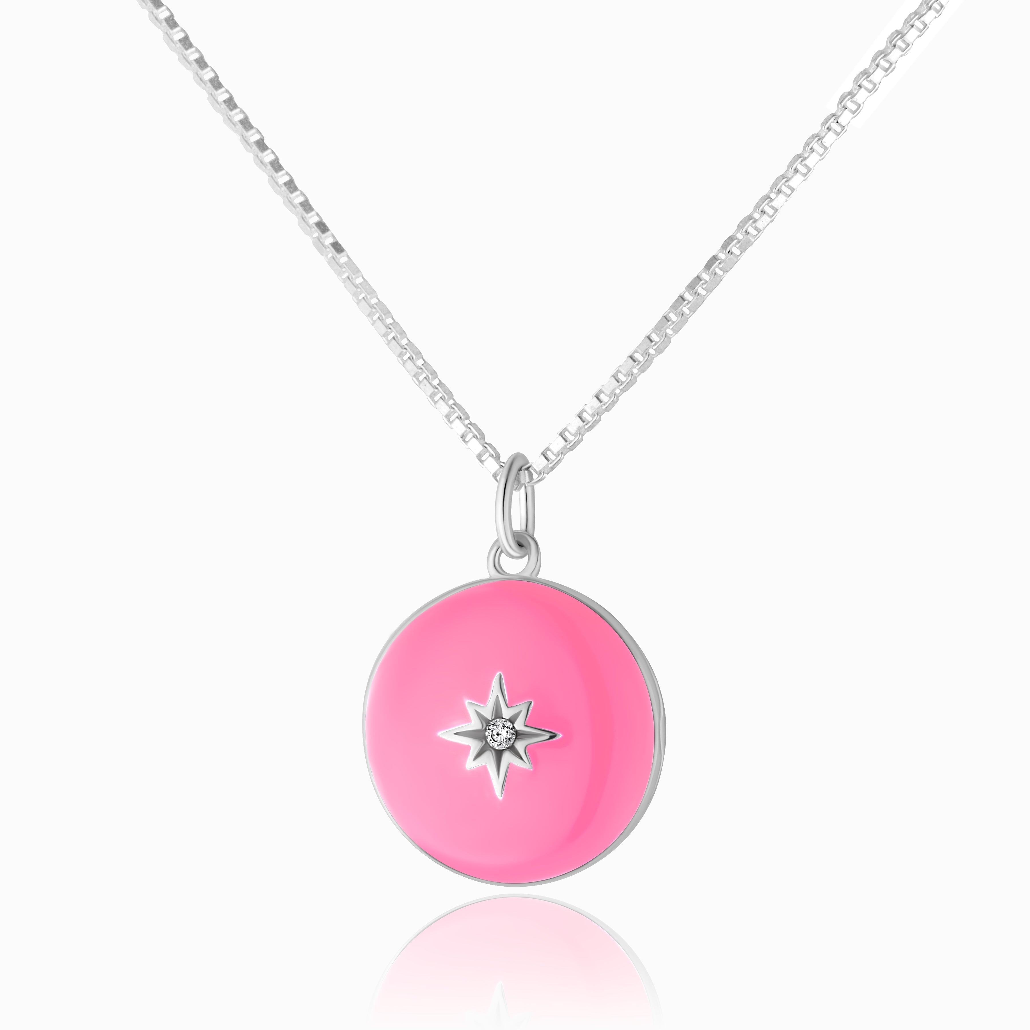 Photo of a 925 sterling silver round locket with a hot pink enamel base, and star set in the middle with a cubic zirconia stone.