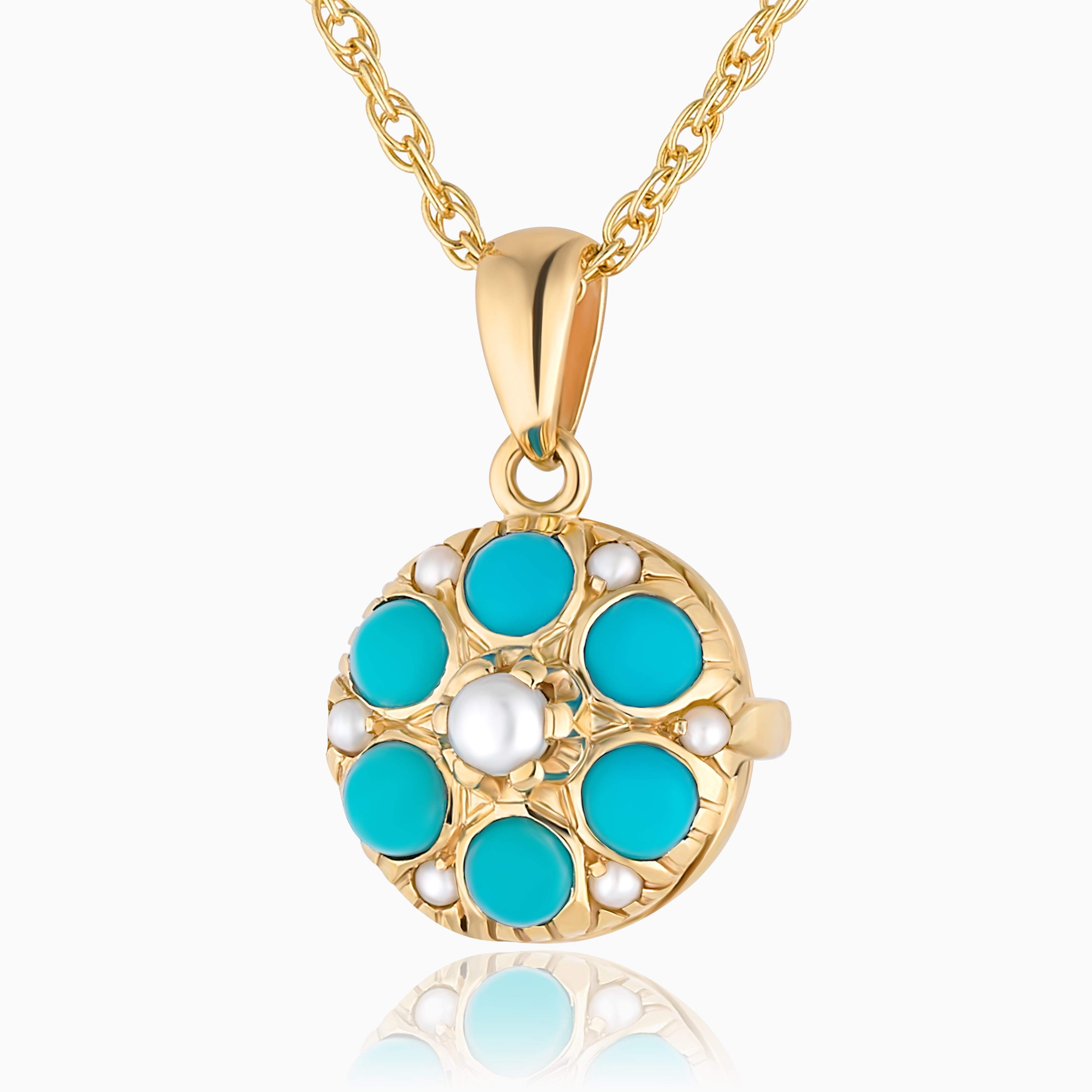 Close up photo of a round 9 ct gold locket with real round turquoise and matching pearls spread throughout and placed on a modern 9ct gold base. Matched with a 9ct gold rope chain.