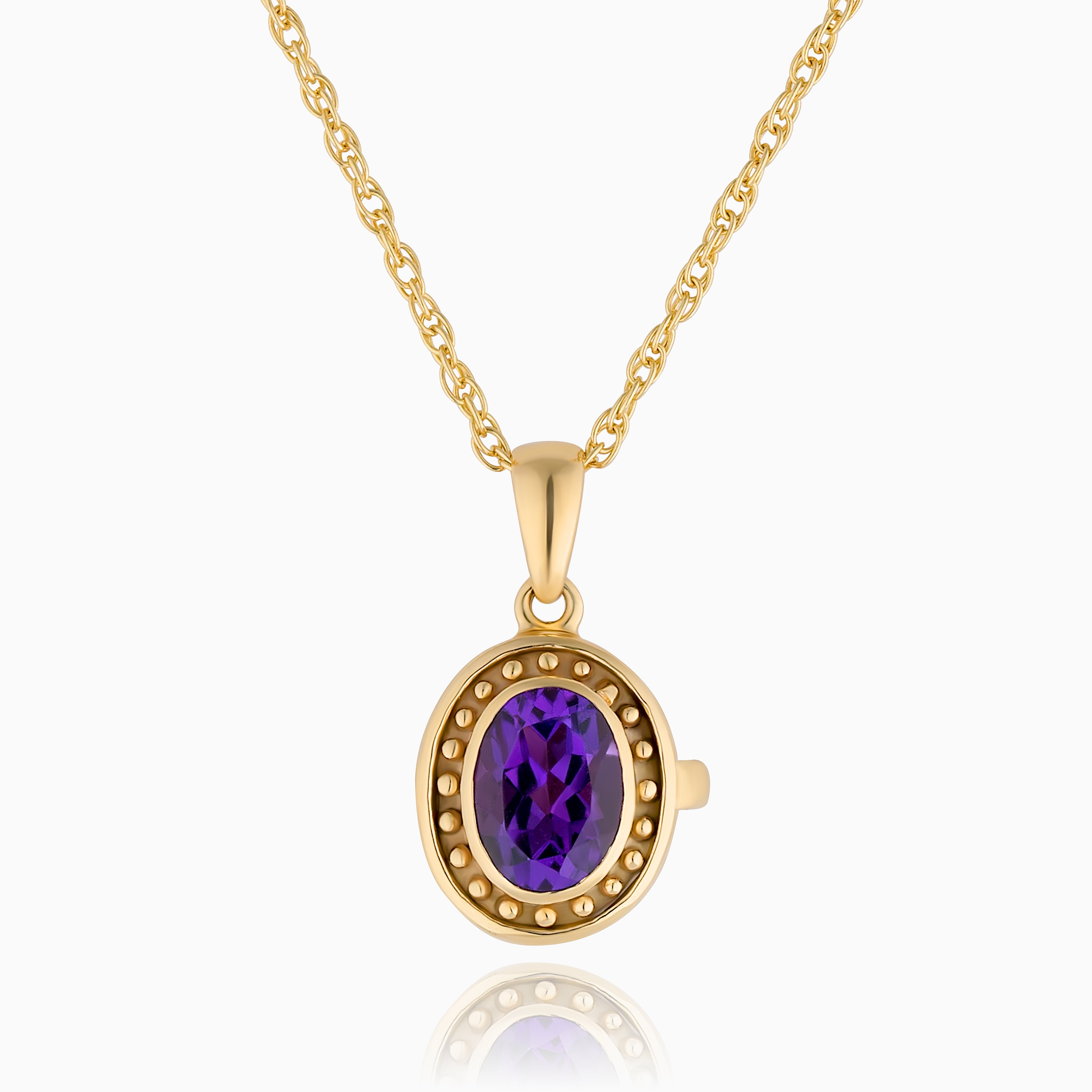 Photo of a 9 ct gold locket with a vibrant purple amethyst in the middle and surrounded by gold beads on the edge of the locket placed on a 9ct rope chain.