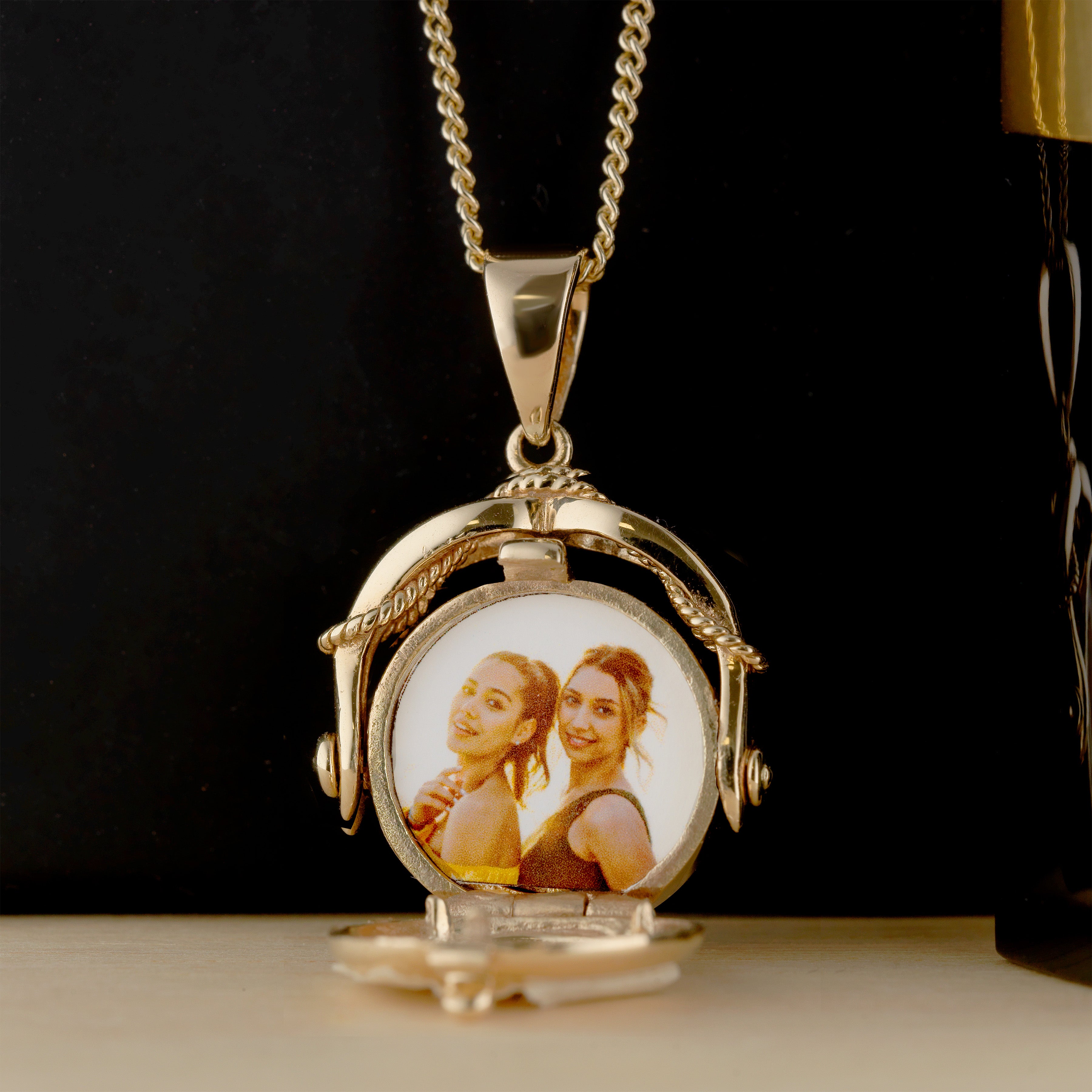 The open view of the swivel locket showing a photo.