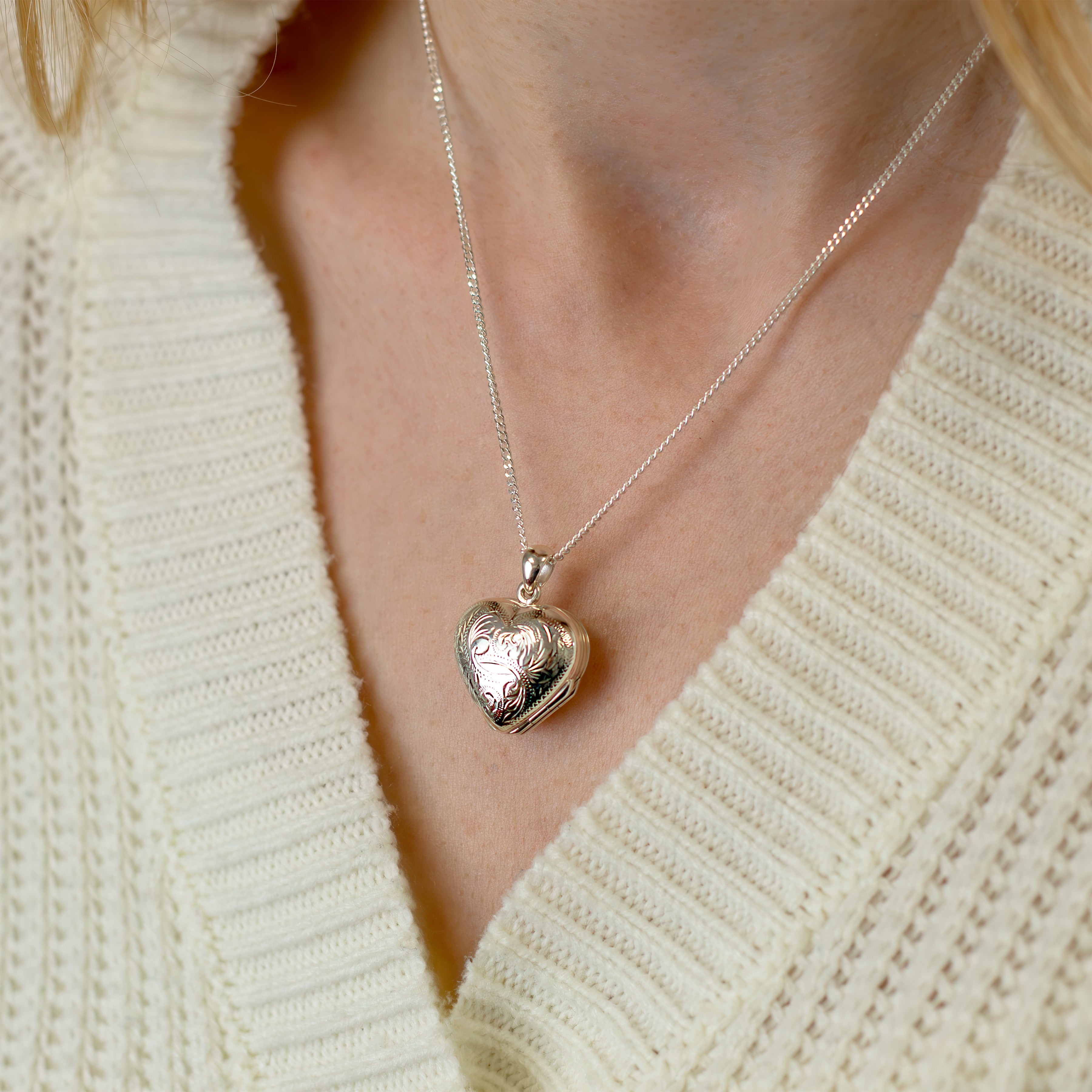 Sterling silver heart-shaped locket with a traditional design on a sterling silver curb chain
