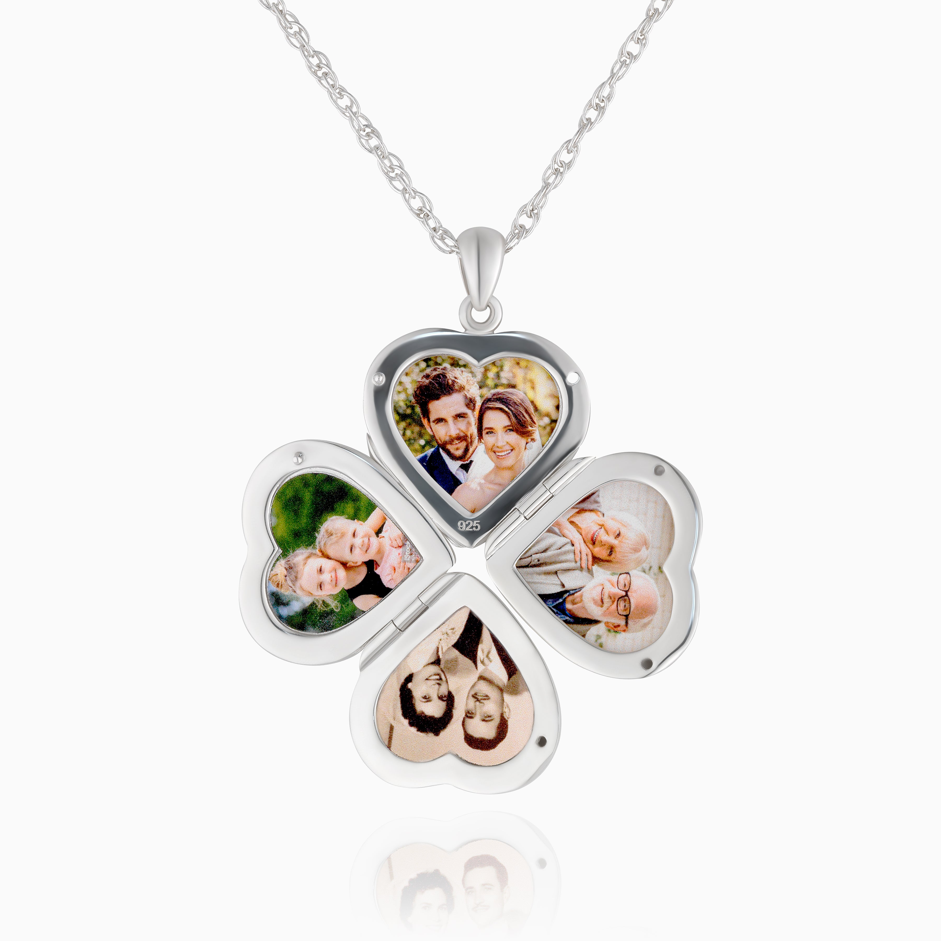 The open view of a sterling silver heart-shaped locket with four photos on a sterling silver rope chain.