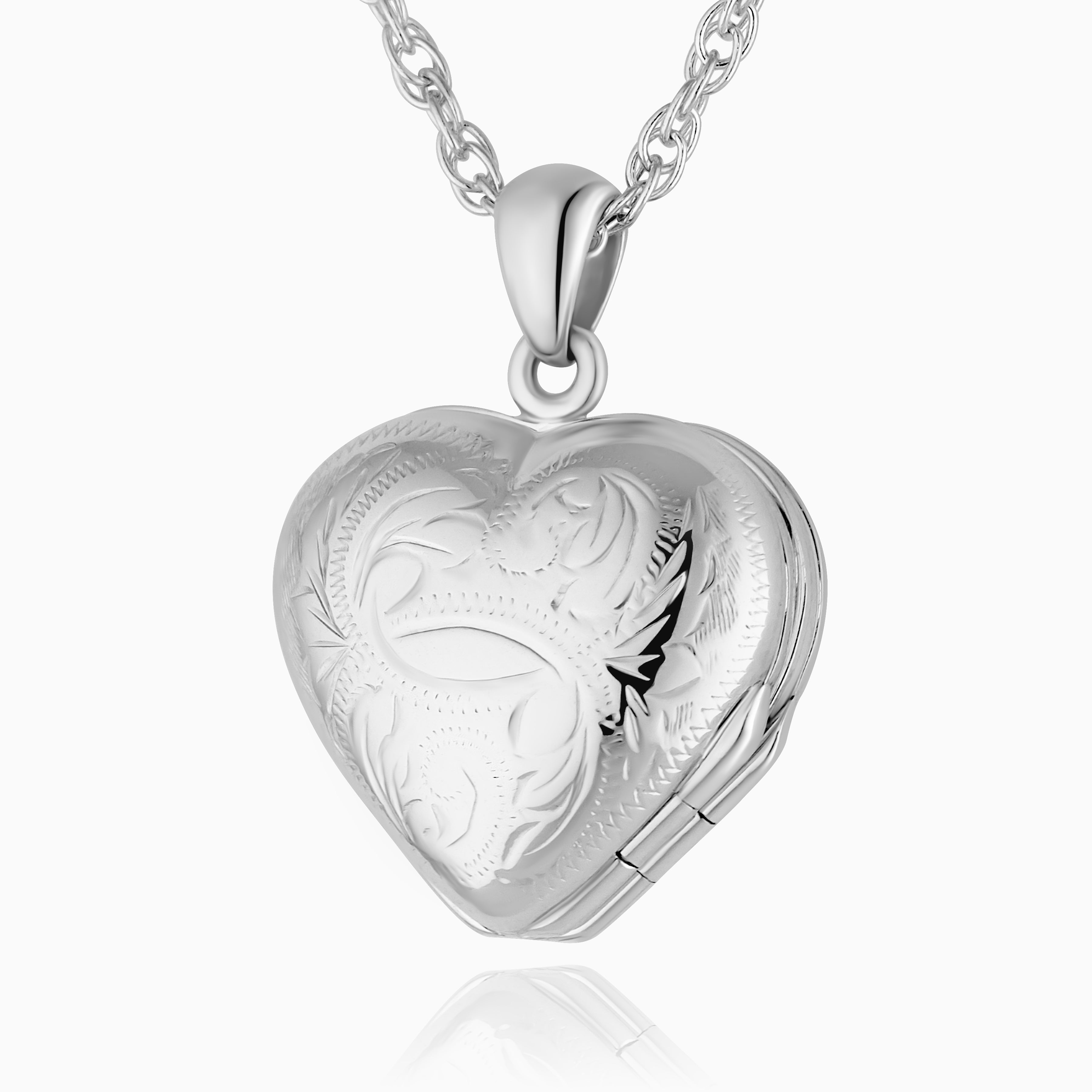 Close up sterling silver heart-shaped locket with a traditional design on a sterling silver curb chain