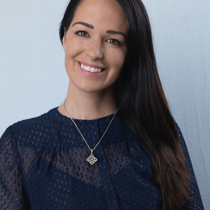 Model wearing a tipped square 9 ct white gold locket set with diamonds and onyx. The bail is also set with diamonds. On a 9 ct white gold curb chain