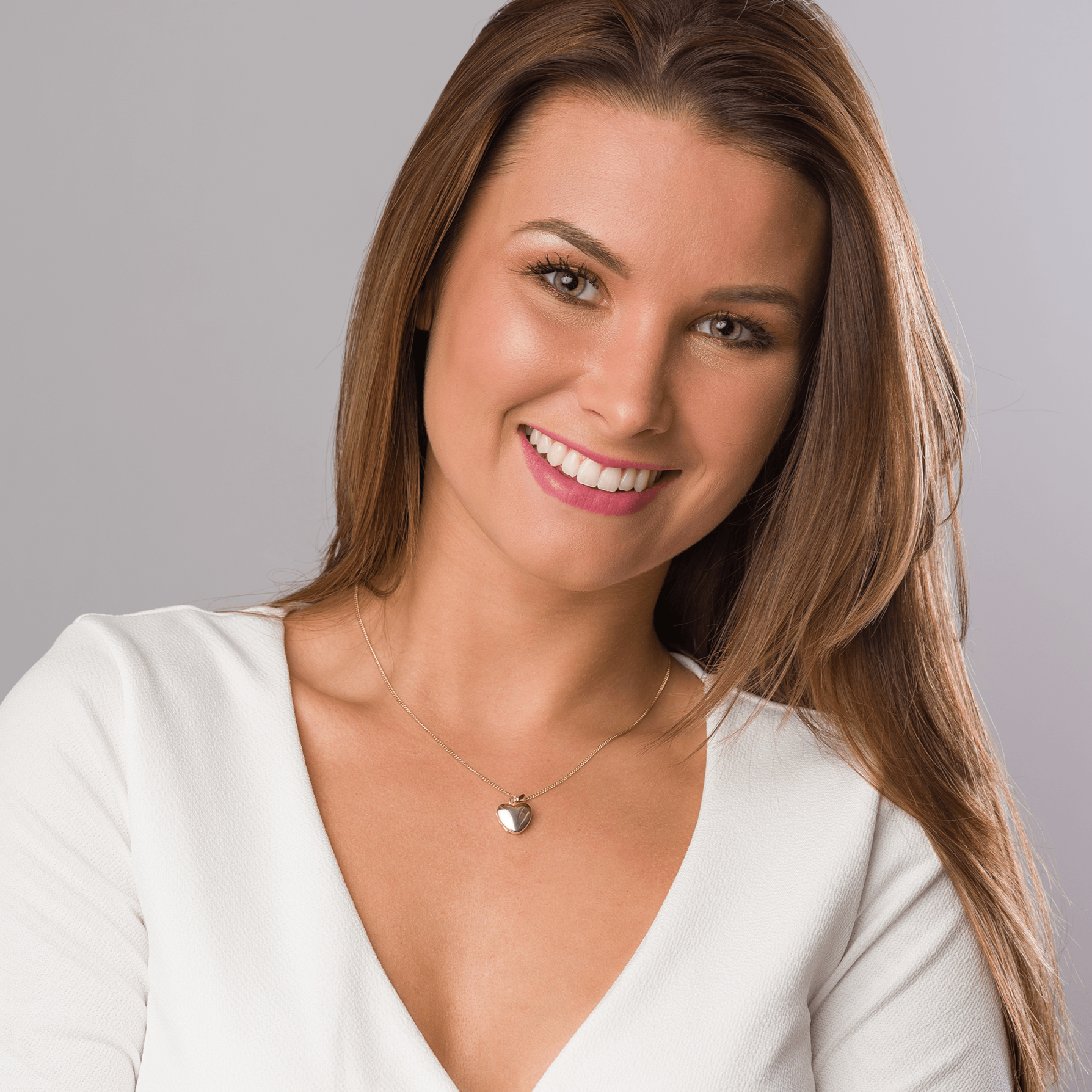 Model wearing a petite 9 ct gold polished heart locket on a 9 ct gold chain