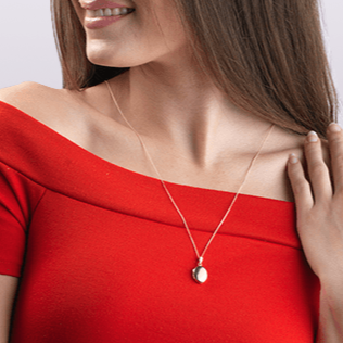 Model wearing a 9 ct gold polished oval locket on a 9 ct gold curb chain