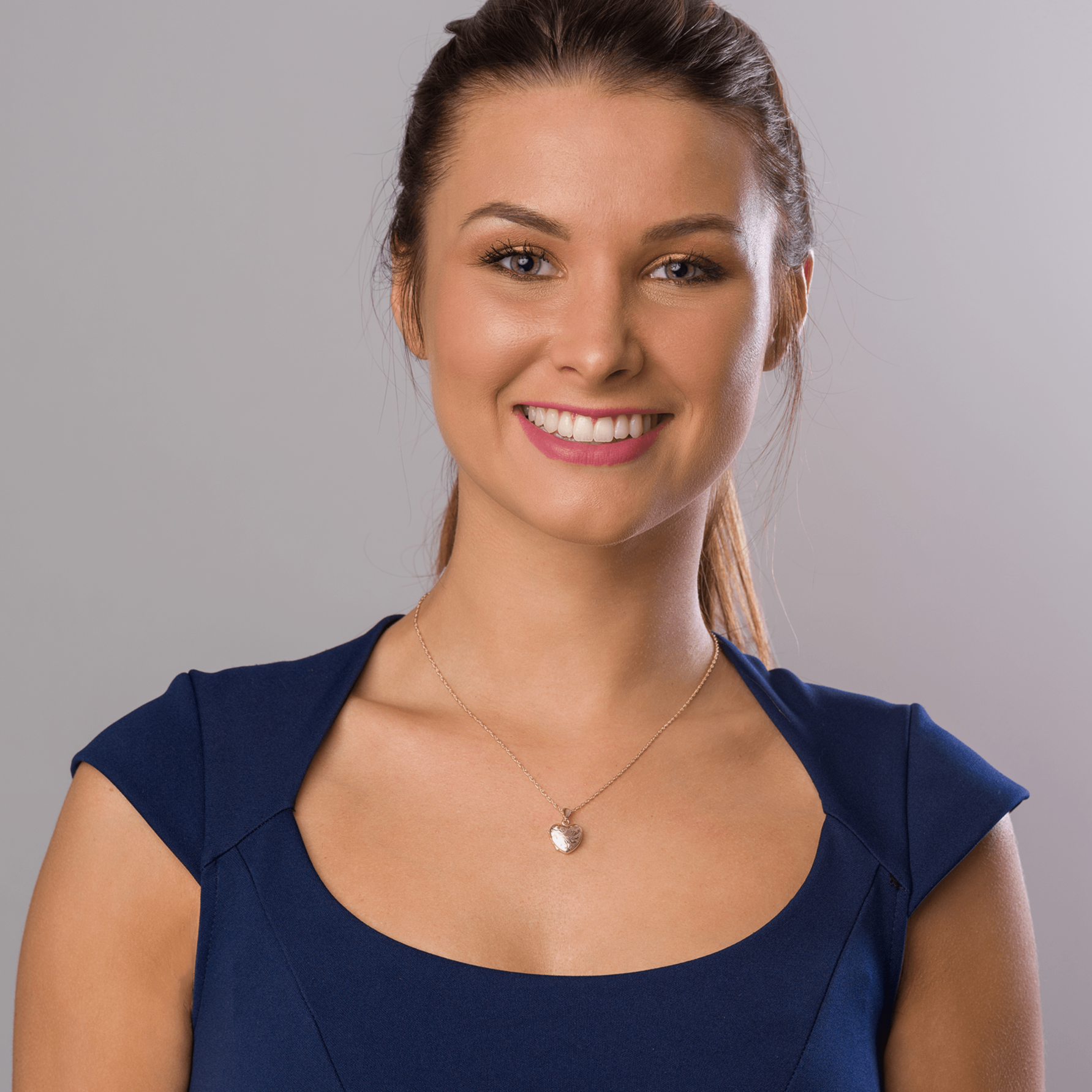 Model wearing a 9 ct gold engraved heart locket on a 9 ct gold rope chain.