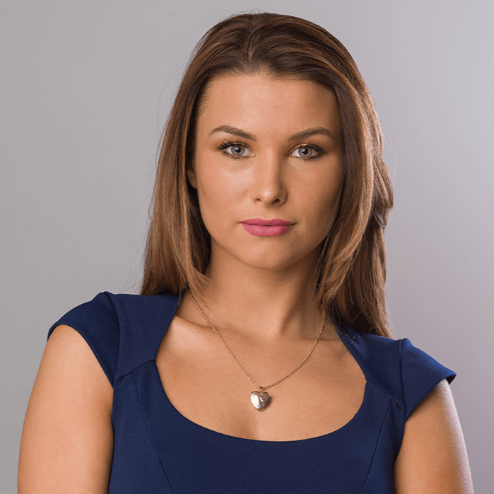 Model wearing a 9 ct gold heart locket with an engraved bird design on a 9 ct gold rope chain