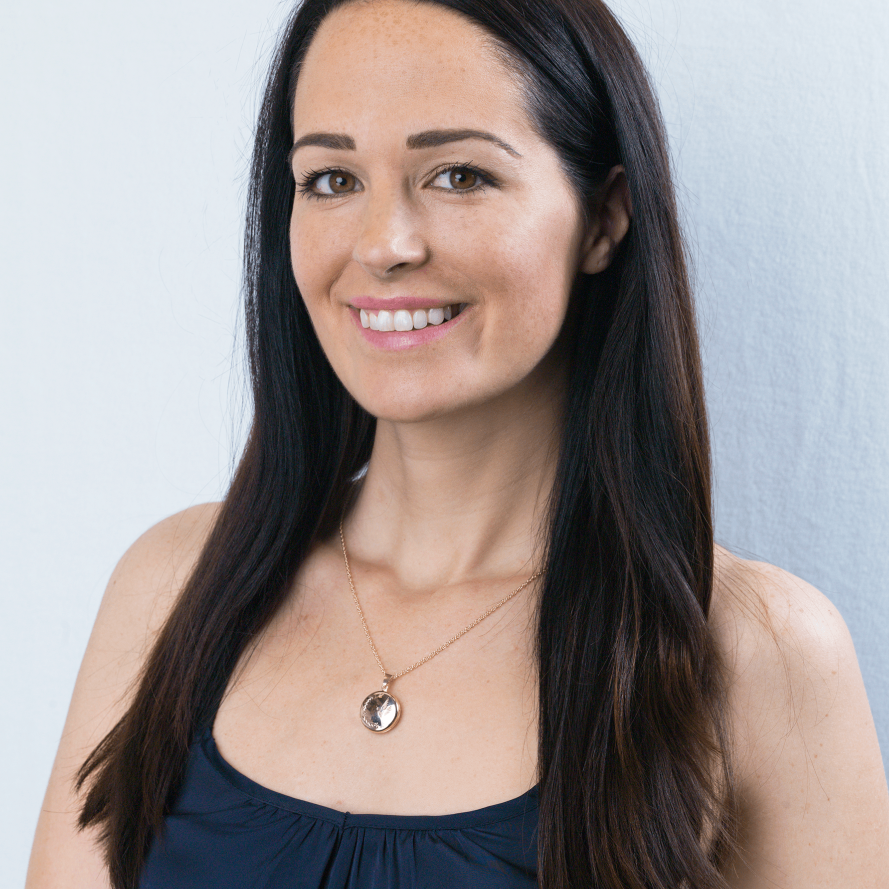 9 ct gold round locket with an engraved bird design on a 9 ct gold rope chain