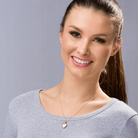 Model wearing a petite 9 ct gold heart locket set with a blue sapphire on a 9 ct gold rope chain