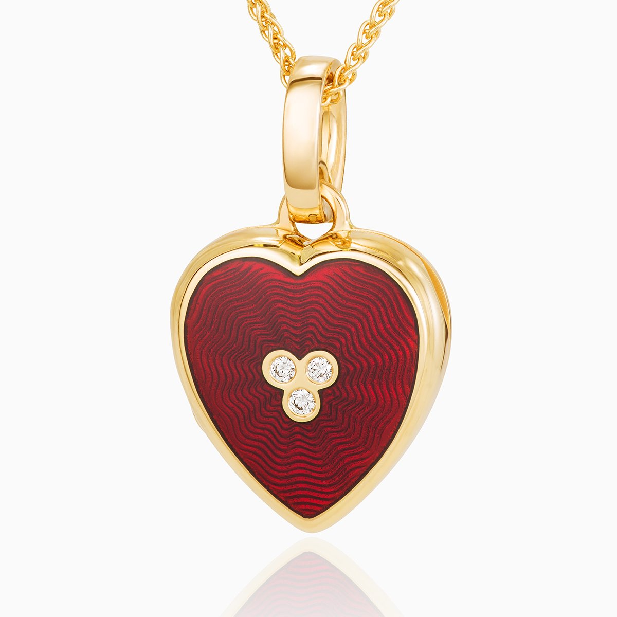 18 ct gold heart locket set with red guilloche enamel and 3 central diamonds on an 18 gold spiga chain