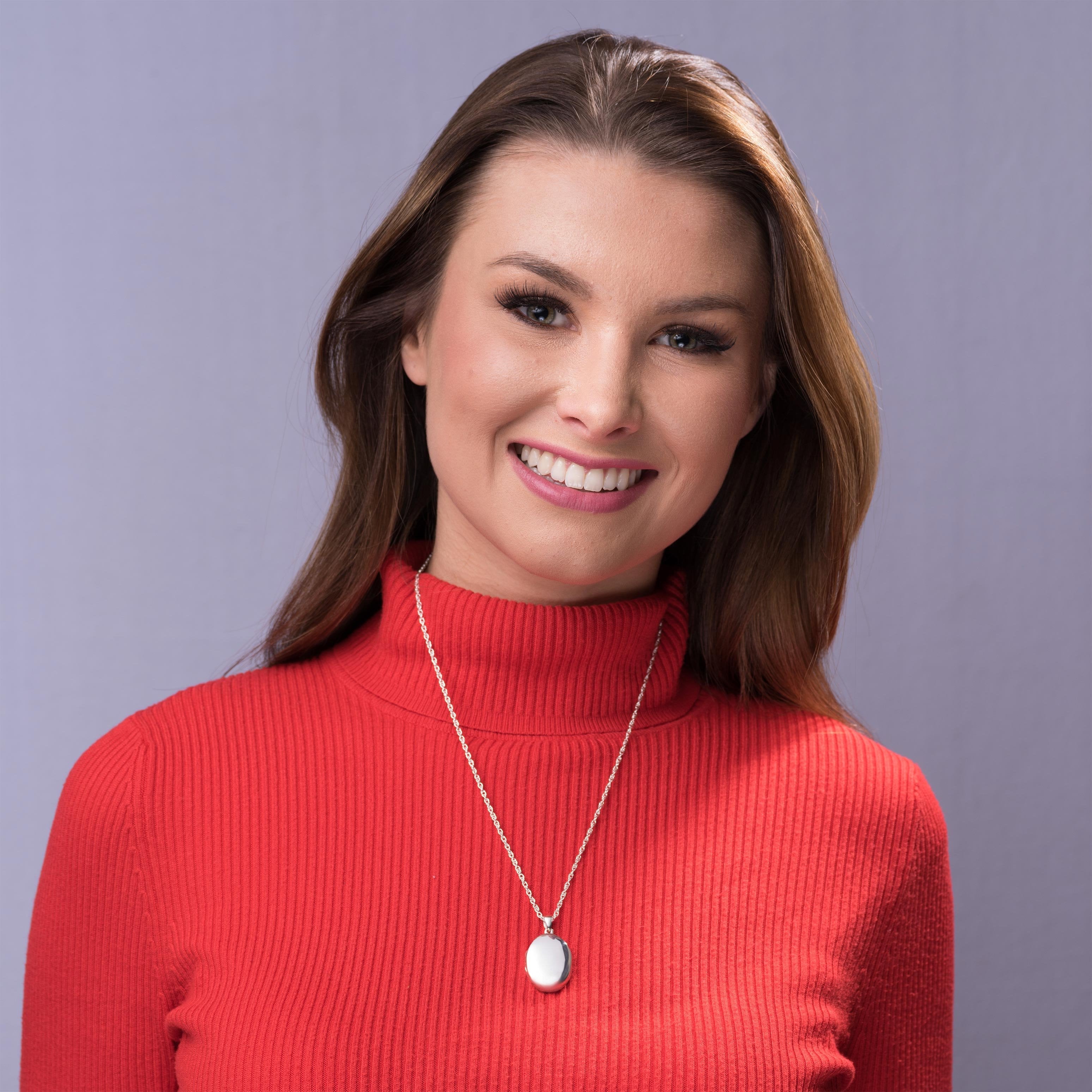 model wearing a sterling silver oval 4-photo locket on a sterling silver rope chain