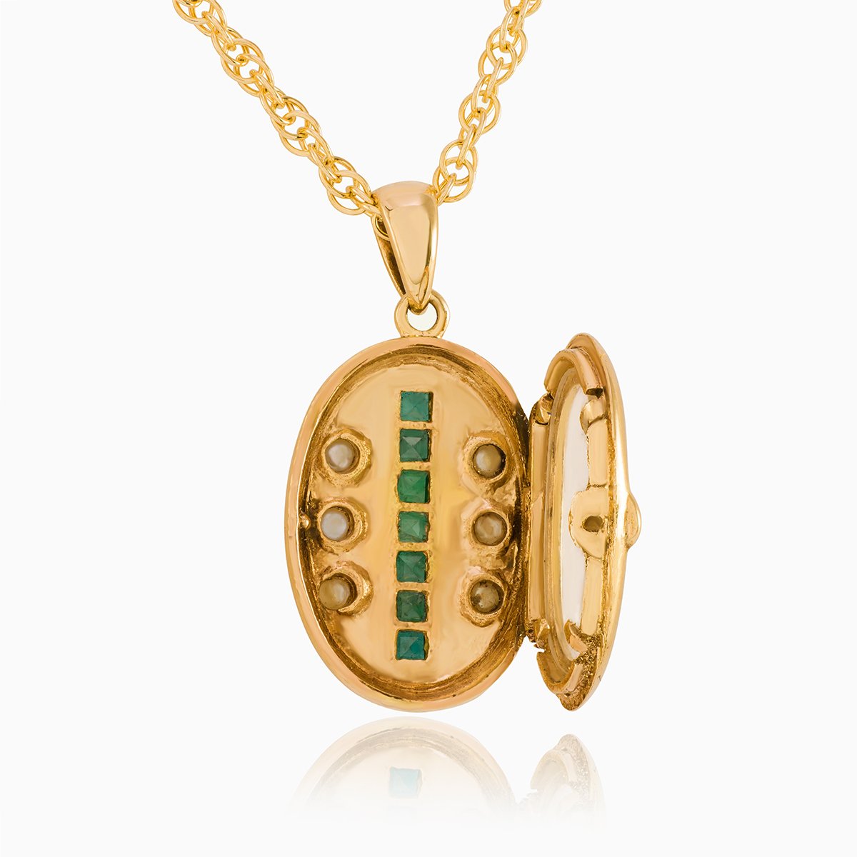 Open view of a petite 9 ct gold oval locket set with emeralds and seed pearls on a 9 ct gold rope chain.