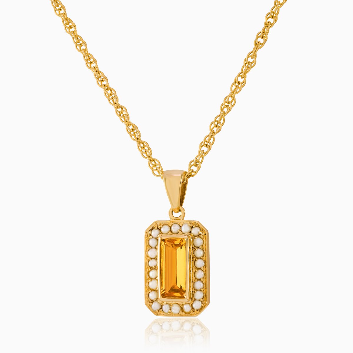 9 ct gold tabular shaped locket set with a citrine and seed pearls ona 9 ct gold rope chain