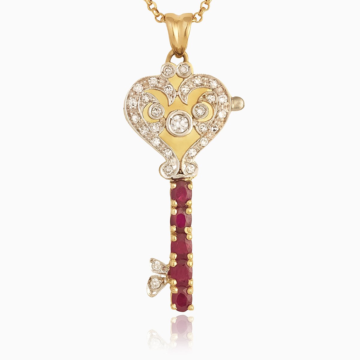 18 ct gold locket in the shape of a key set with diamonds and rubies, on an 18 ct gold trace chain