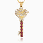 18 ct gold locket in the shape of a key set with diamonds and rubies, on an 18 ct gold trace chain
