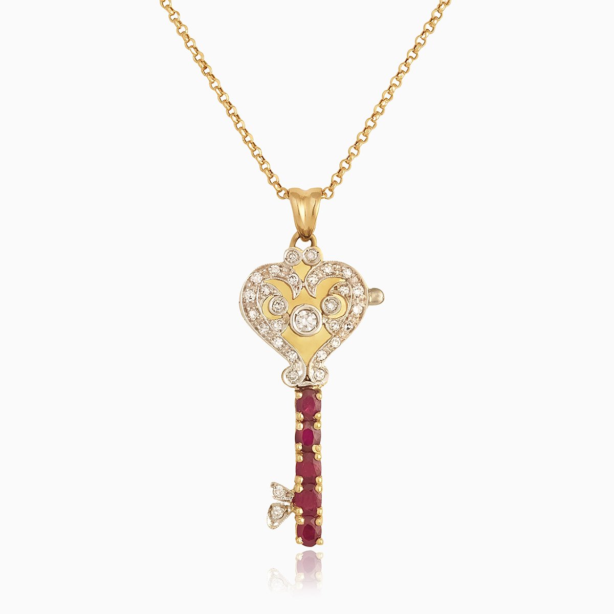 18 ct gold locket in the shape of a key set with diamonds and rubies, on an 18 ct gold trace chain