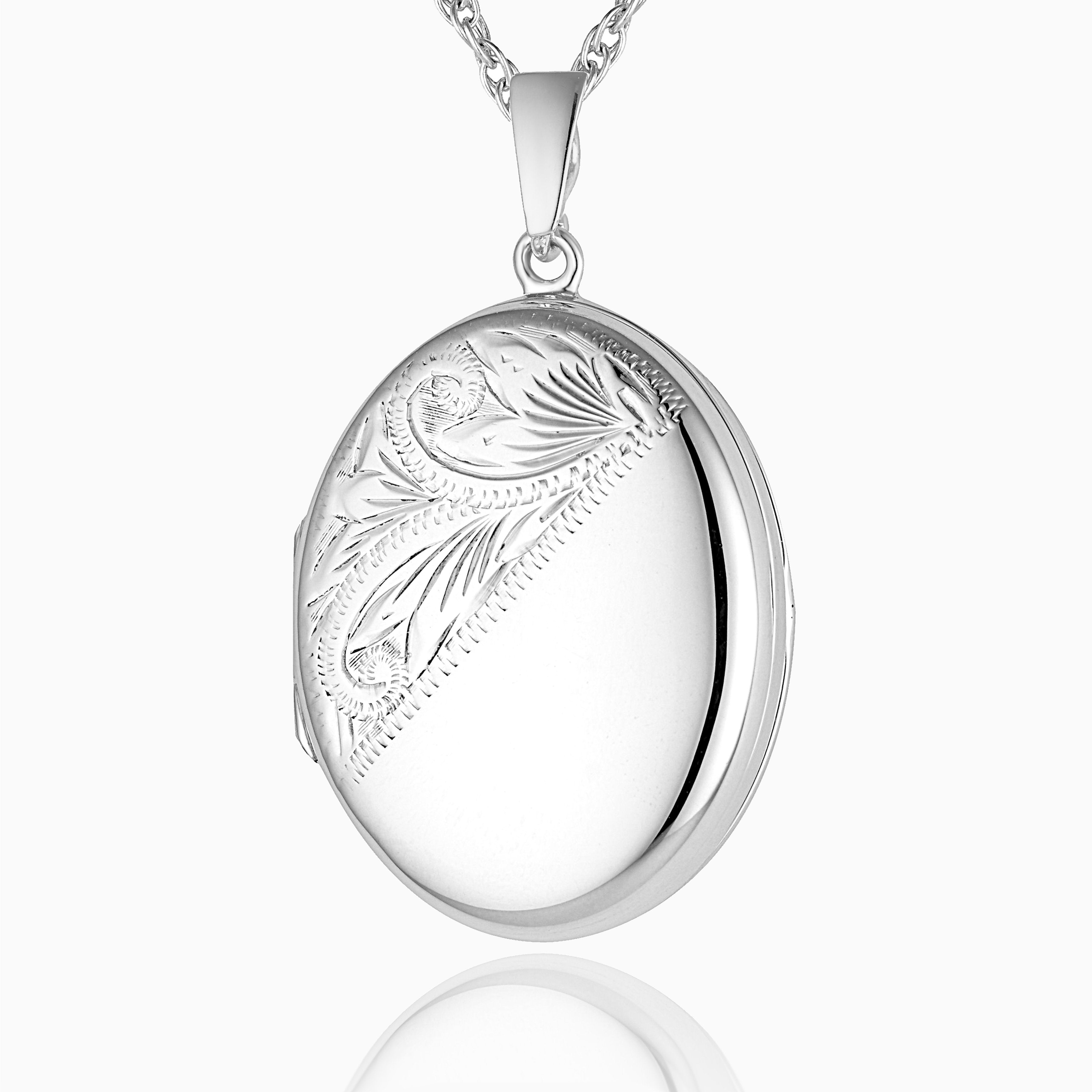 sterling silver oval locket with an engraved foliate design across the left diagonal