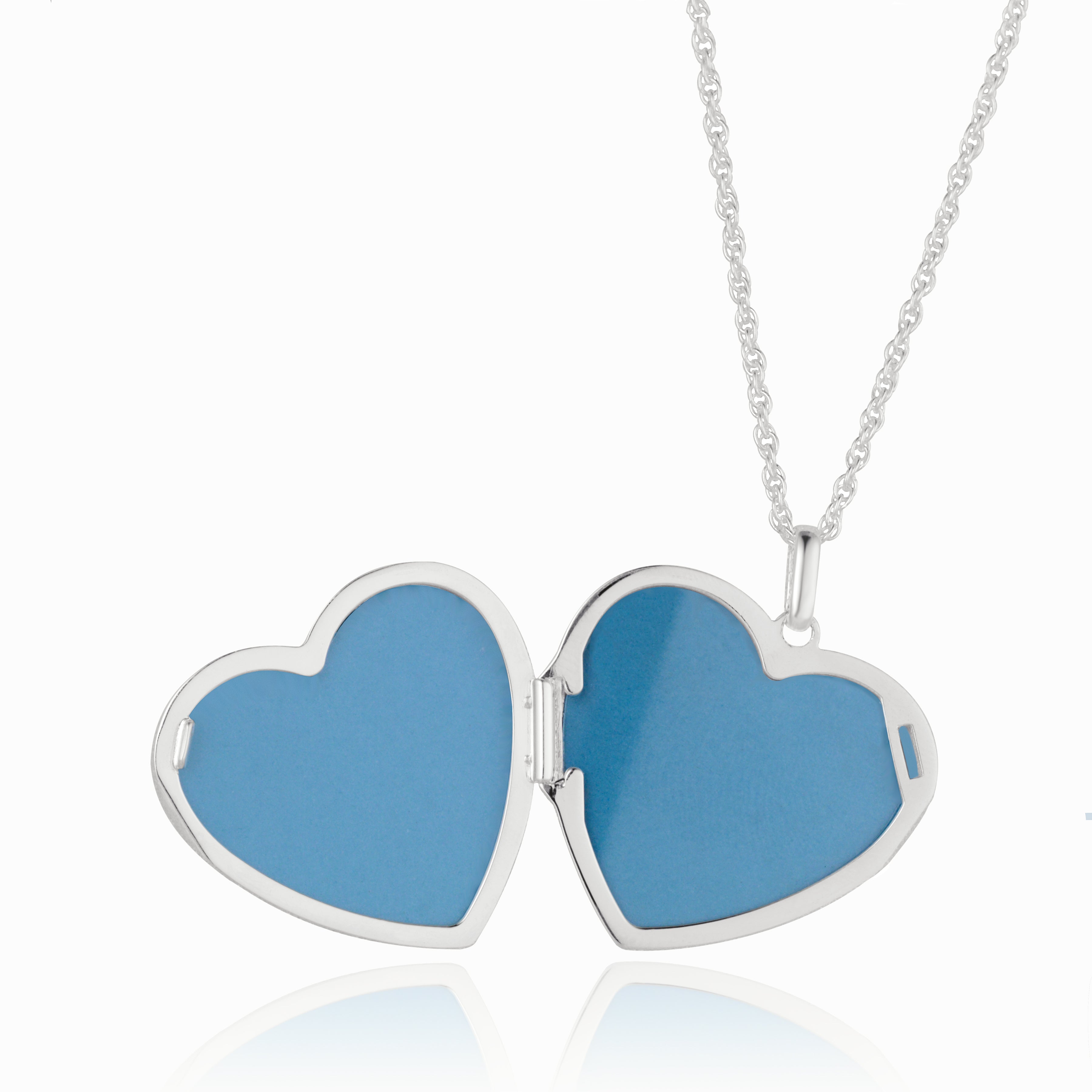 Open shot of a large polished sterling silver heart locket, set on a sterling silver curb chain.