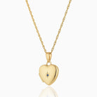 Petite 9 ct gold heart locket set with a blue sapphire on a 9 ct gold rope chain
