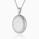 sterling silver oval locket engraved all over with a floral design, hanging on a sterling silver rope chain