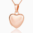Front shot of a petite 9 ct rose gold heart locket on a 9 ct rose gold curb chain.