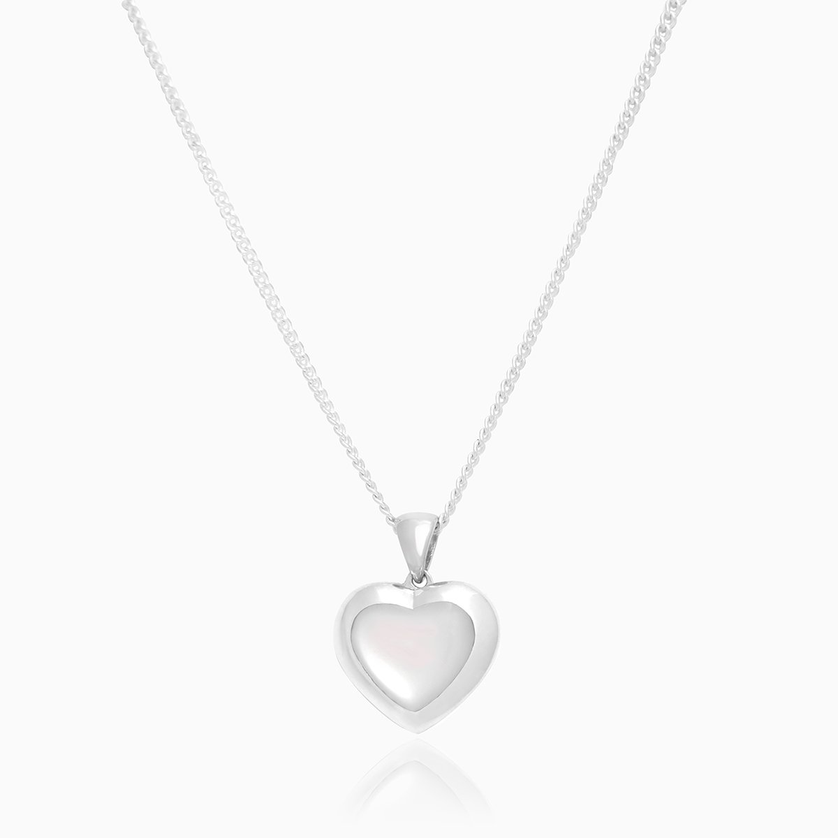 Front shot of a petite heart-shaped sterling silver locket set with white mother of pearl on a sterling silver curb chain.