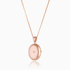 9 ct rose gold 4-photo oval locket set with a diamond on a 9 ct rose gold curb chain