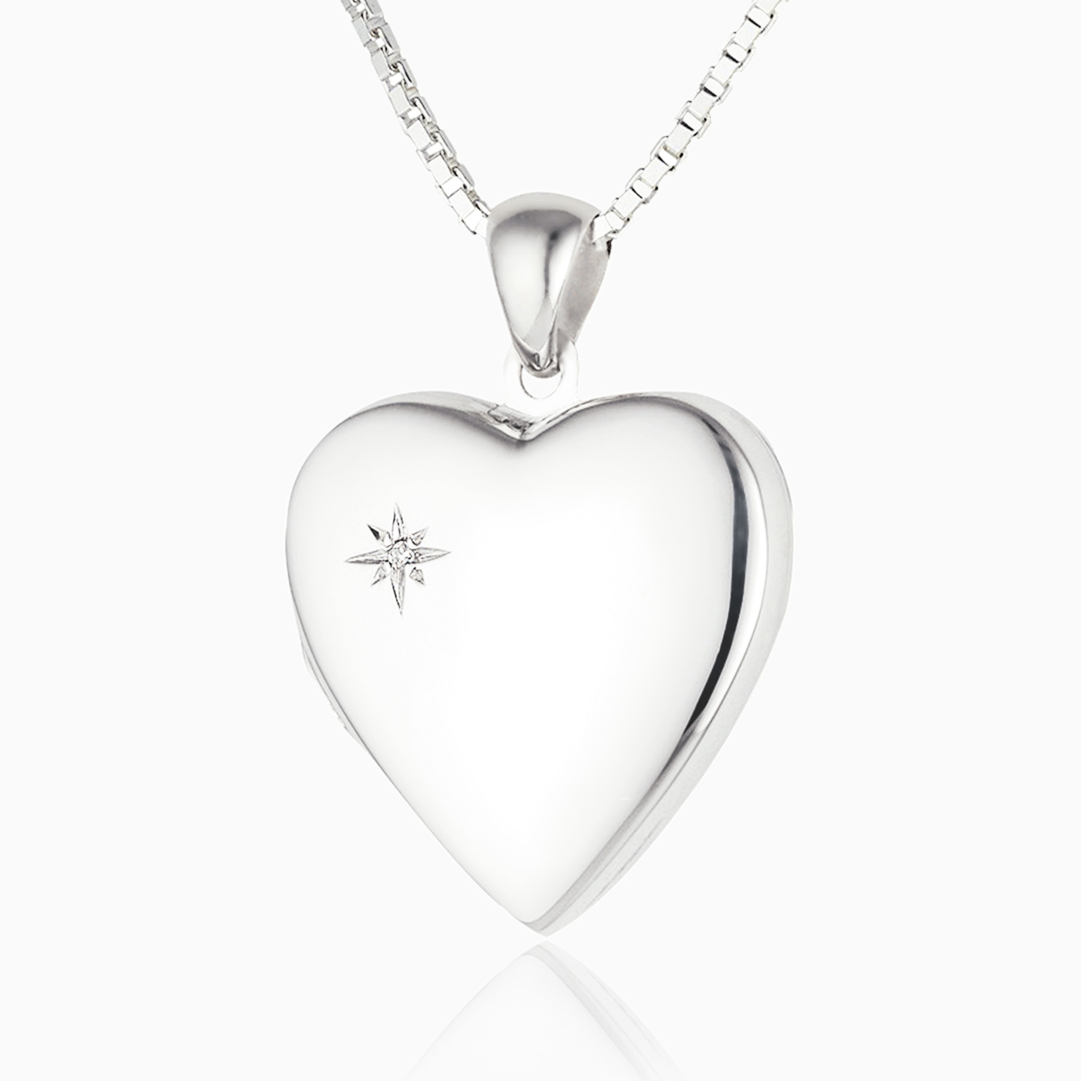 sterling silver heart locket set with a diamond in the top left corner, on a sterling silver curb chain