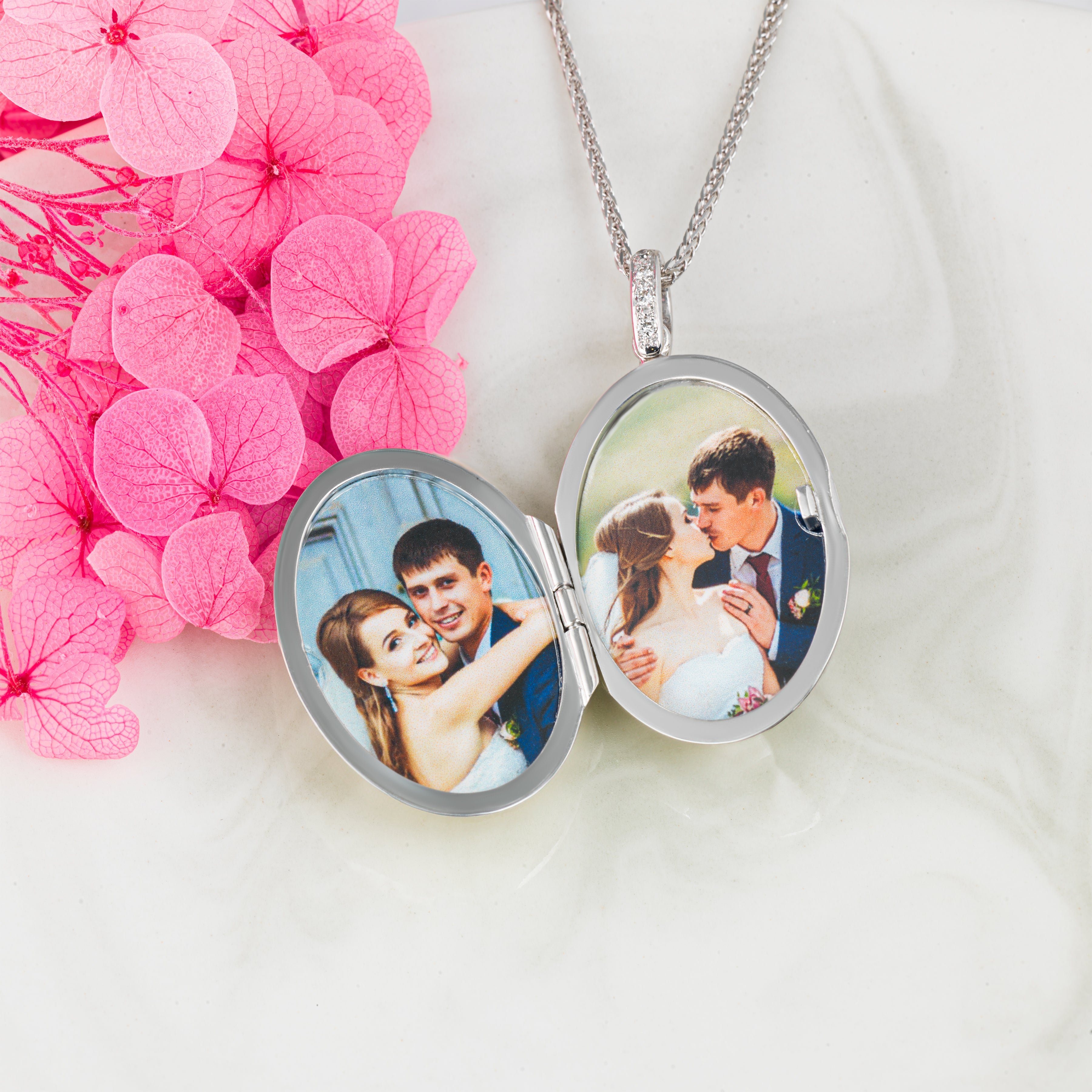 This is an open shot for 18 ct Contemporary White Gold and Diamond Locket with a 18ct Spiga Chain, displaying two photos with a wedding couple. 