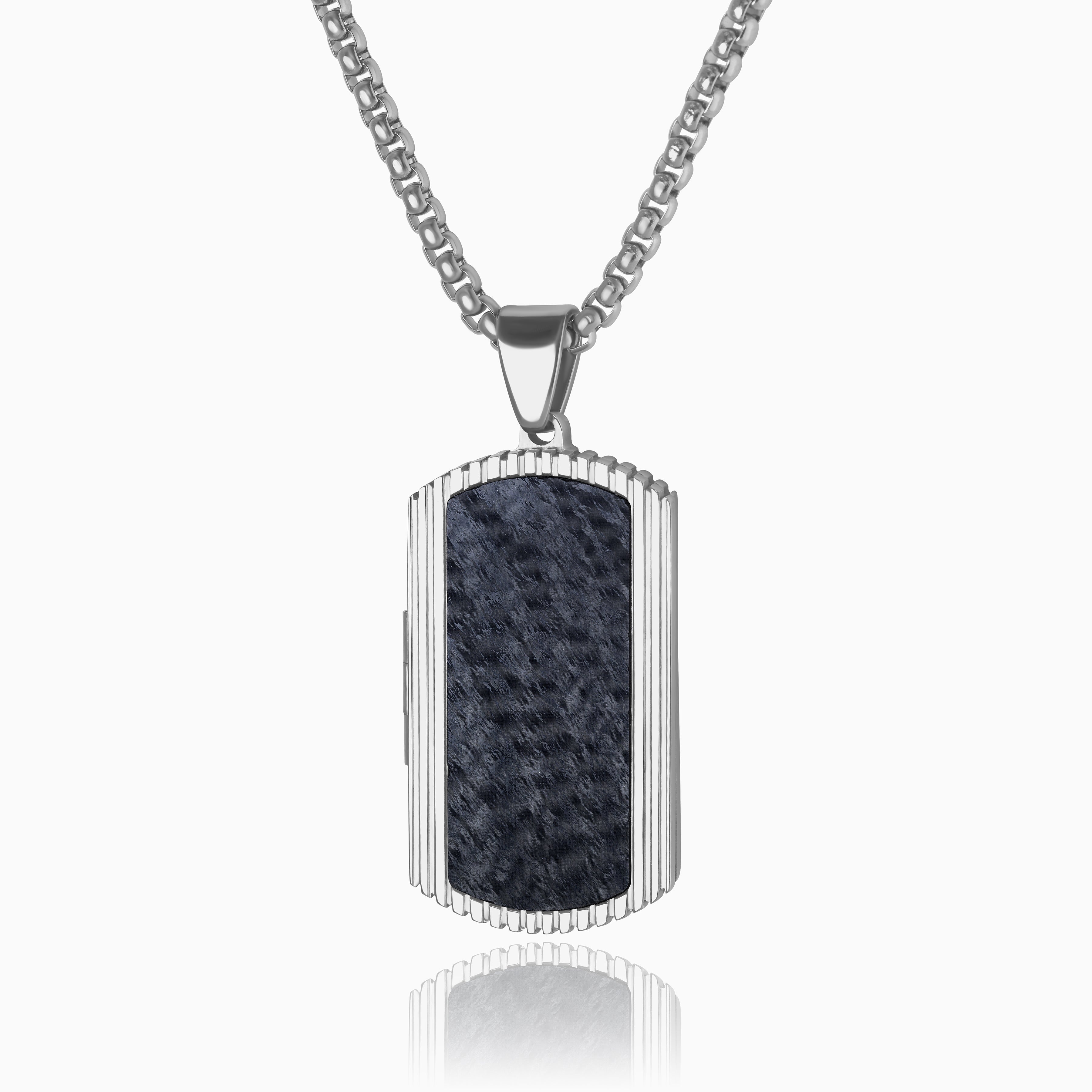 Photo of a stainless steel and forged carbon fibre men's dog tag locket with a ridged edge and dark marble background placed on sterling silver chain