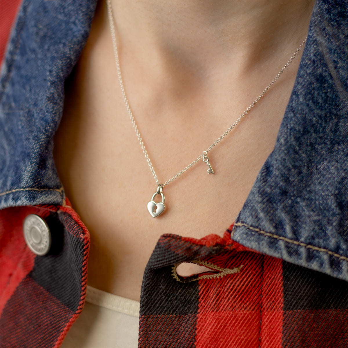 Sterling silver heart shaped pendant with a key on a sterling silver rope chain.