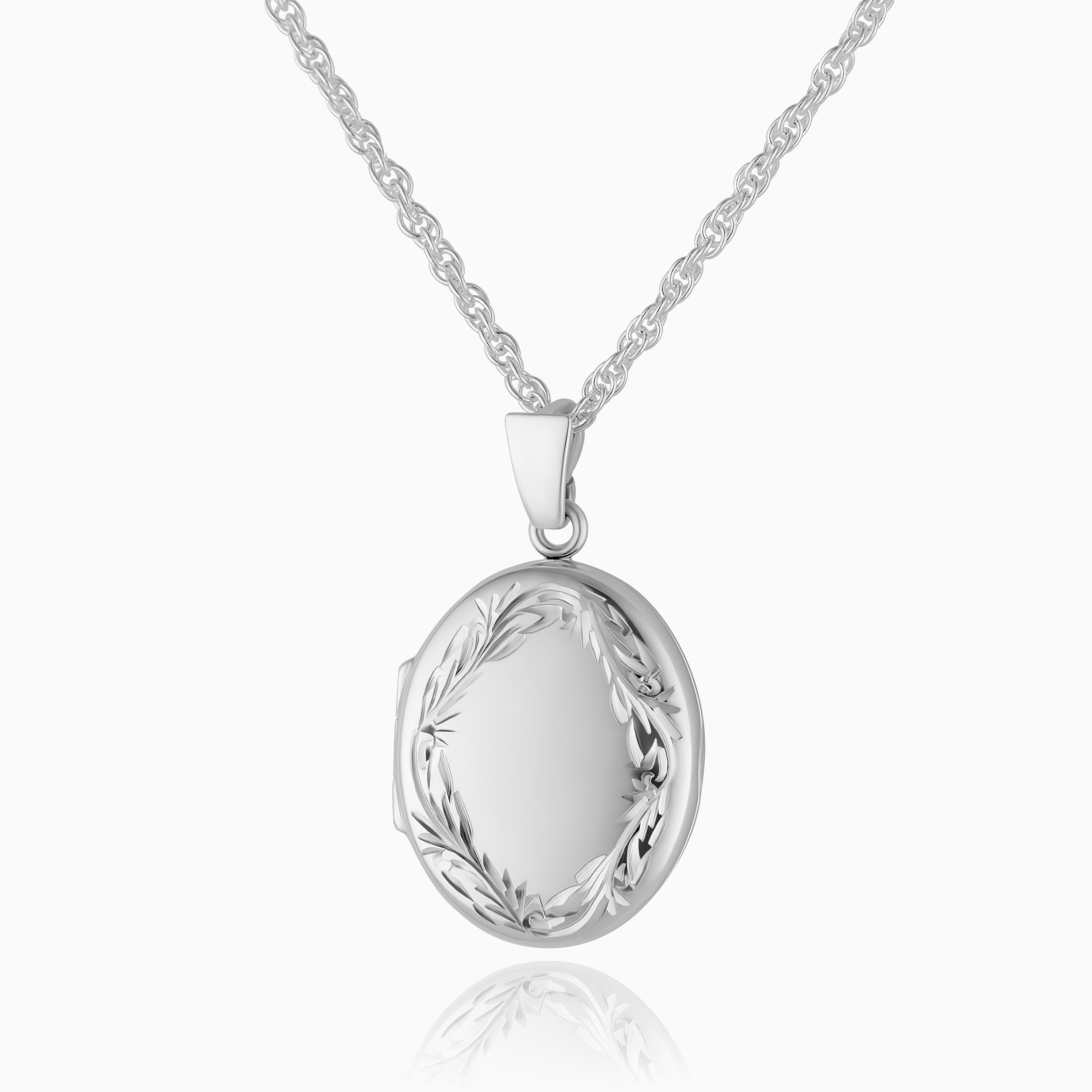 photo of a 925 sterling silver locket with a hand-engraved traditional foliate border placed on a curb chain.