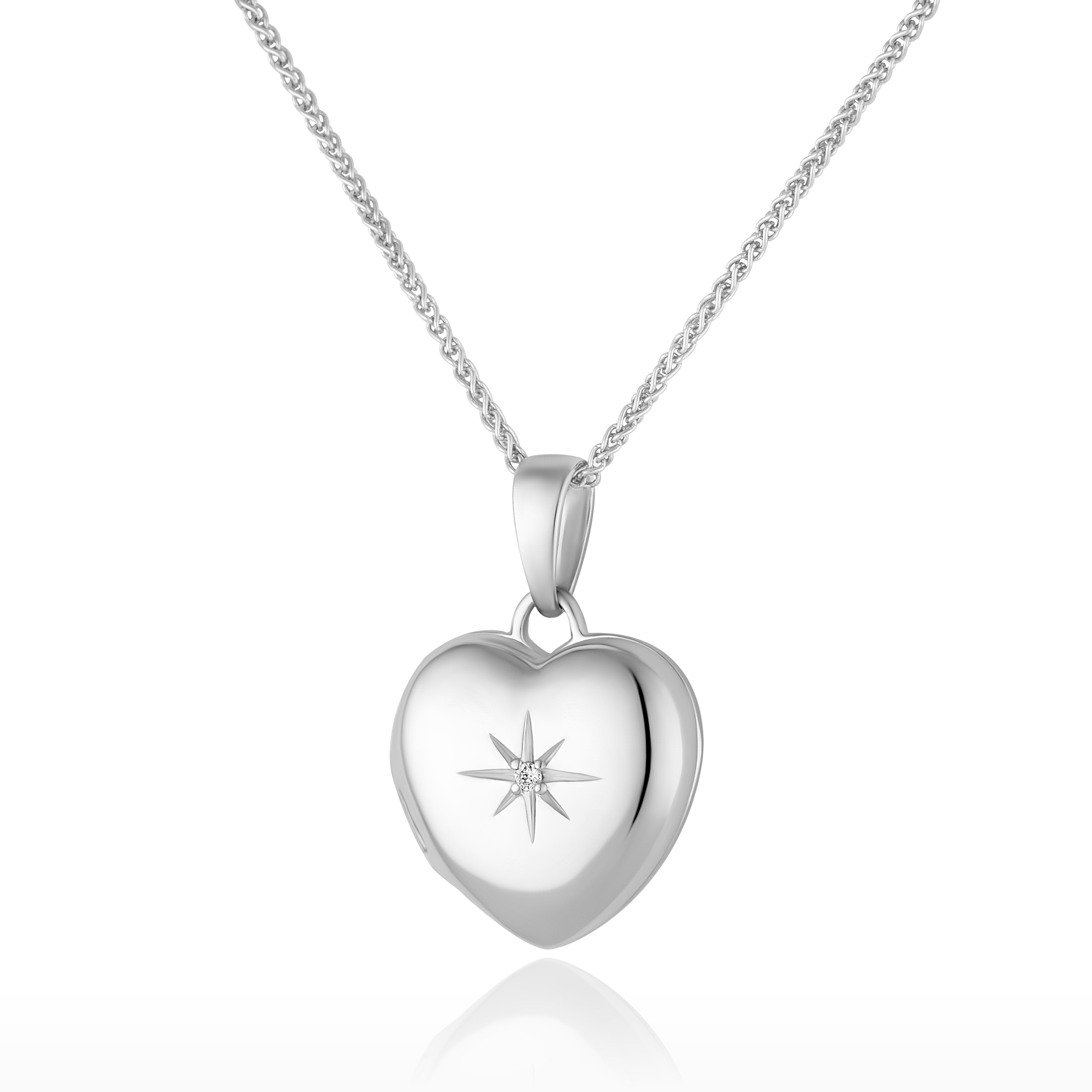 Photo of a premium petite white gold heart locket with a star set diamond in the middle and placed on a curb chain.