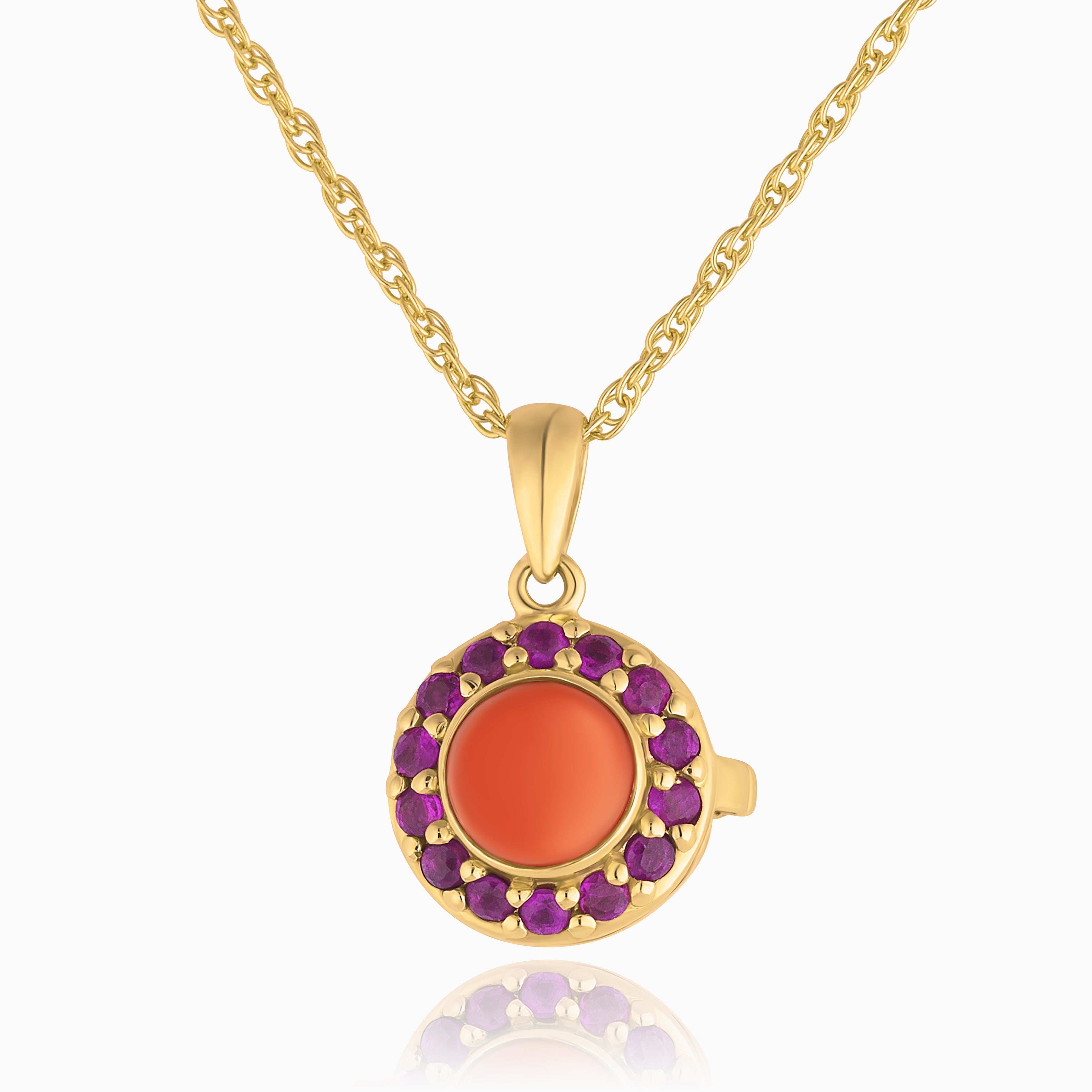 Photo of a petite round 9 ct gold locket with a red coral in the middle and matching rubies surrounding it placed on a 9 ct gold base with a 9ct gold chain accompanying it.