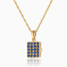 Photo of a 9ct gold rectangular locket studded with real sapphires placed on a 9ct gold rope chain.