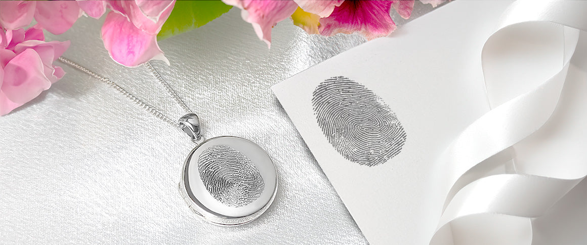 A fingerprint engraved on a silver locket beside the original fingerprint