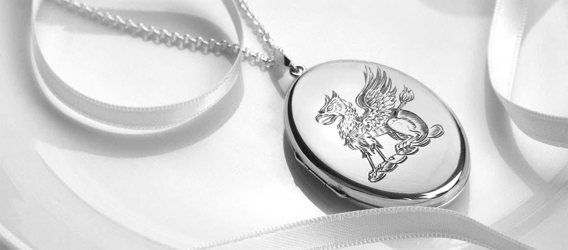 A griffin design engraved on a polished silver oval locket