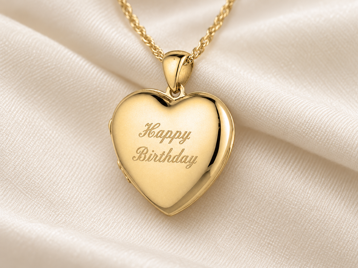 A gold heart locket engraved with a personal message