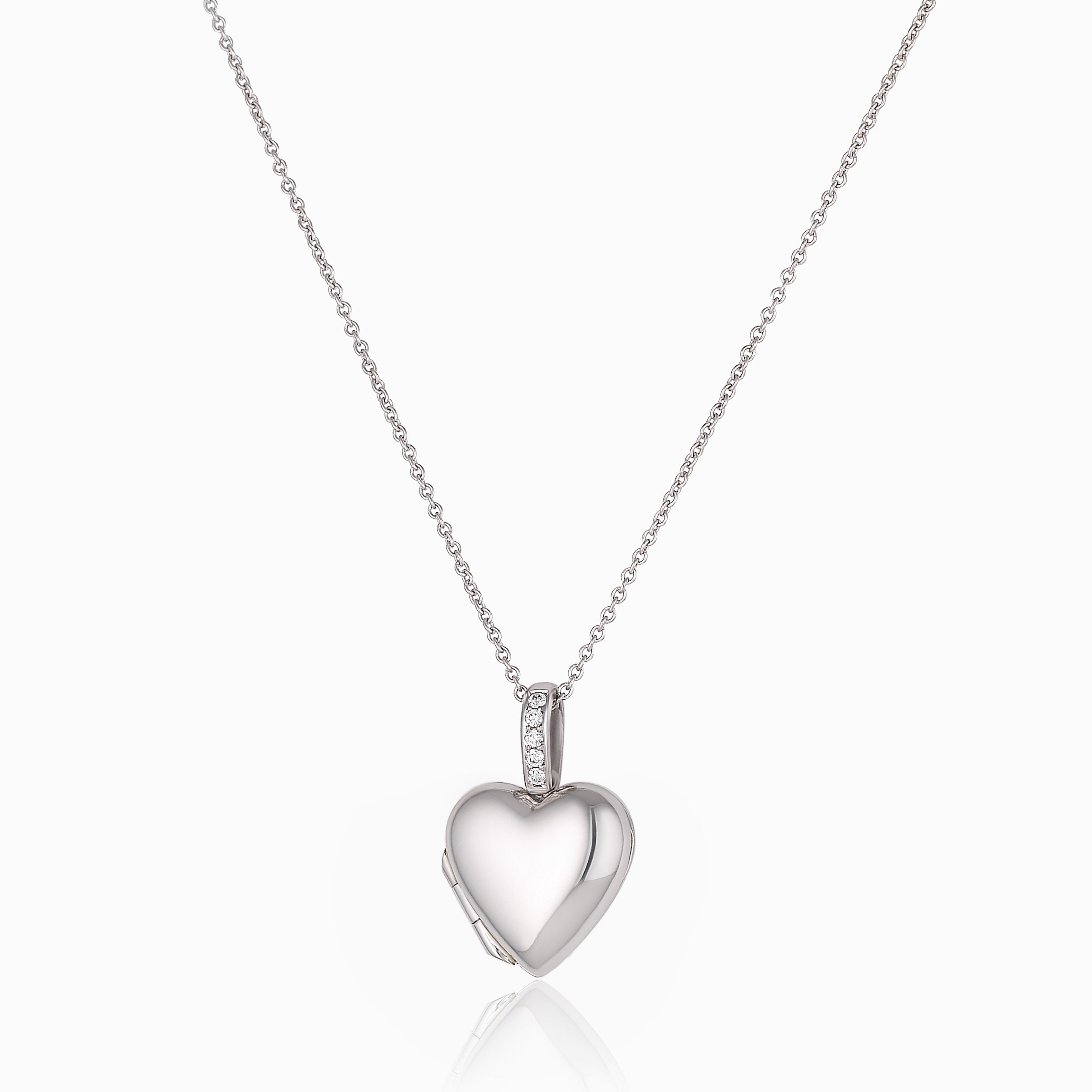 A platinum heart shaped locket, the bail set with diamonds, on a platinum chain.