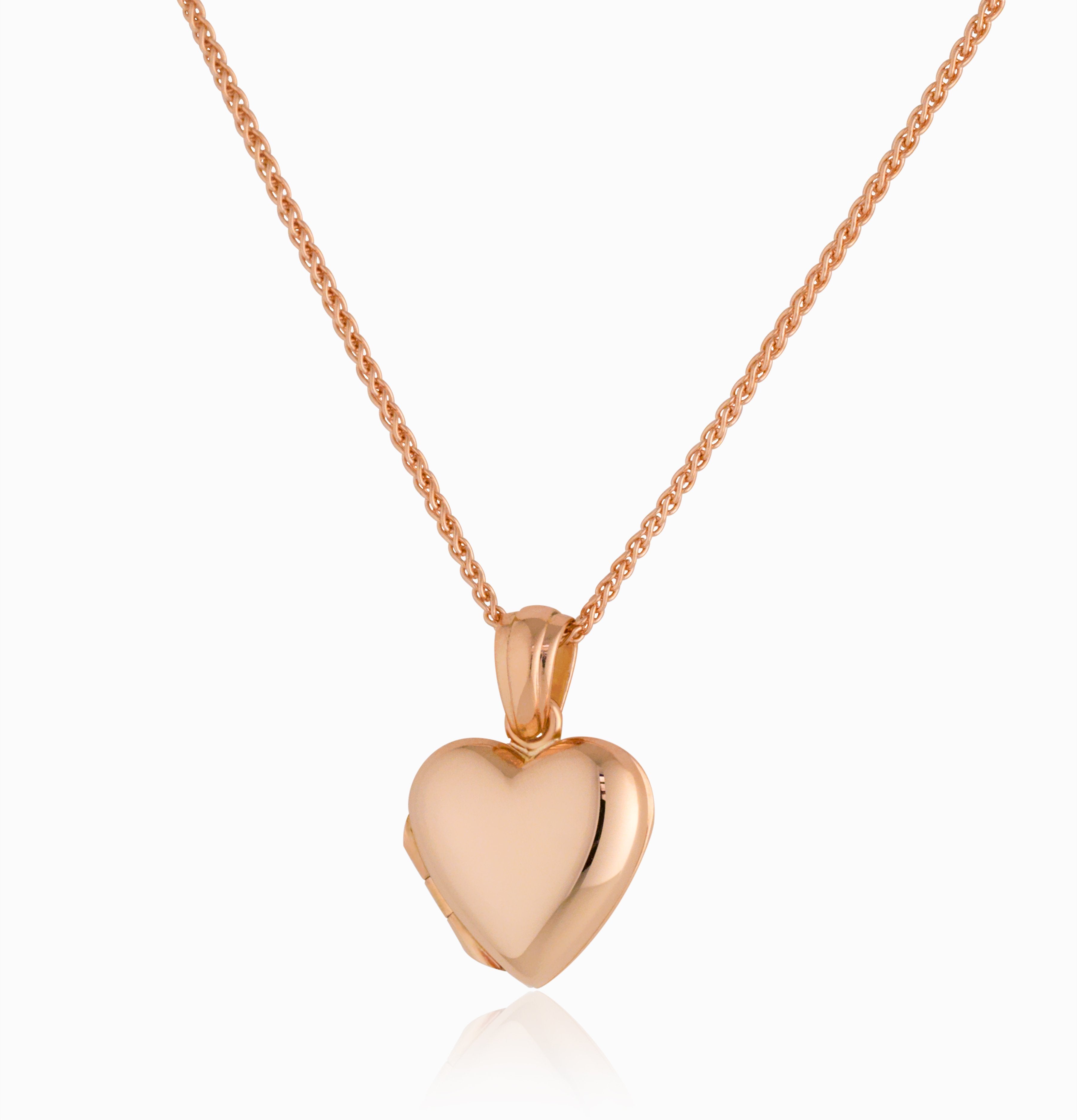 An 18 ct rose gold heart shaped locket hanging on an 18 ct rose gold spiga chain.