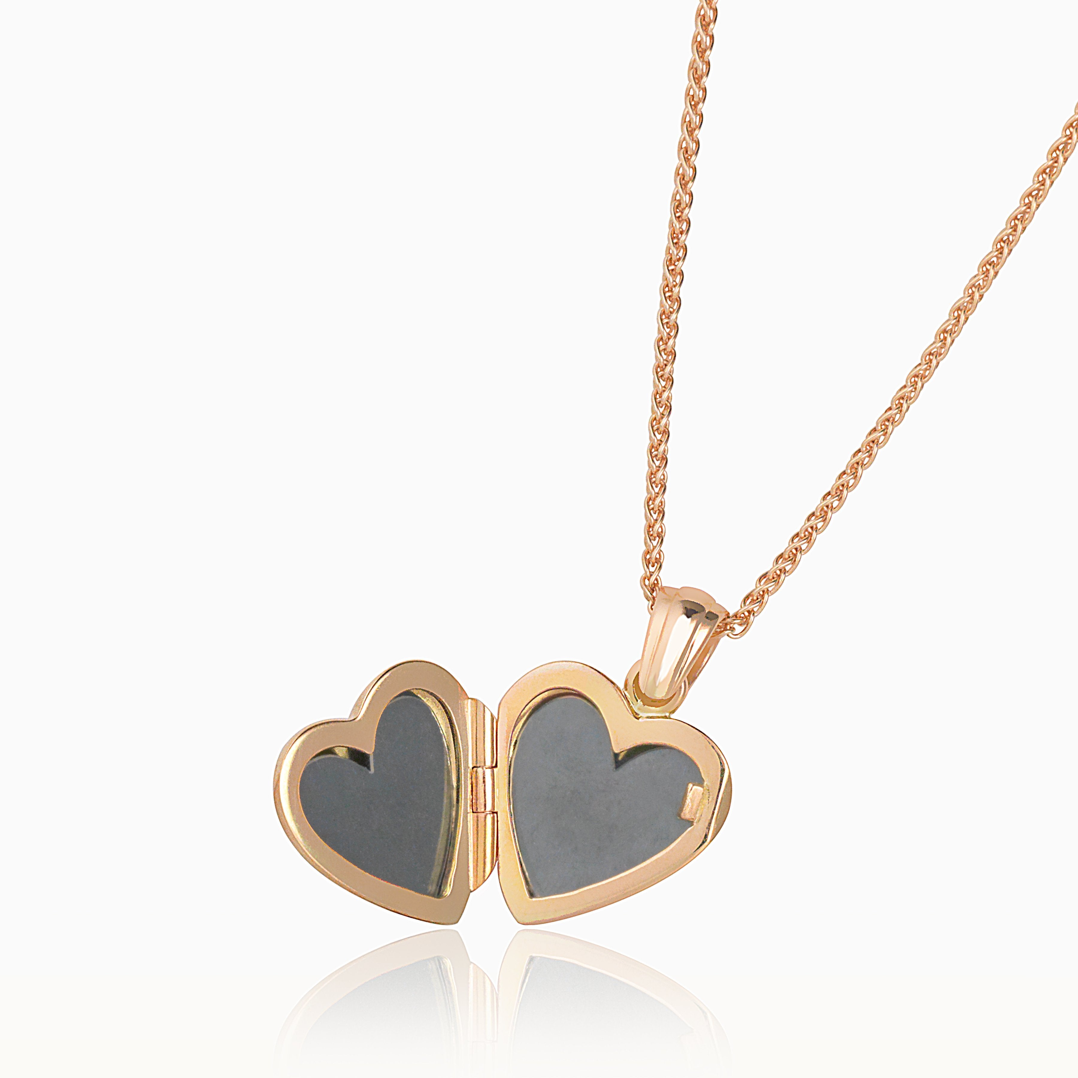 Open view of an 18 ct rose gold heart shaped locket hanging on an 18 ct rose gold spiga chain.