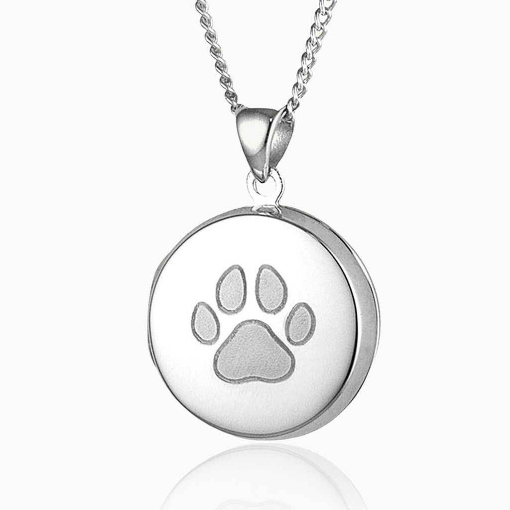 sterling silver round locket with a paw print design engraved on the front