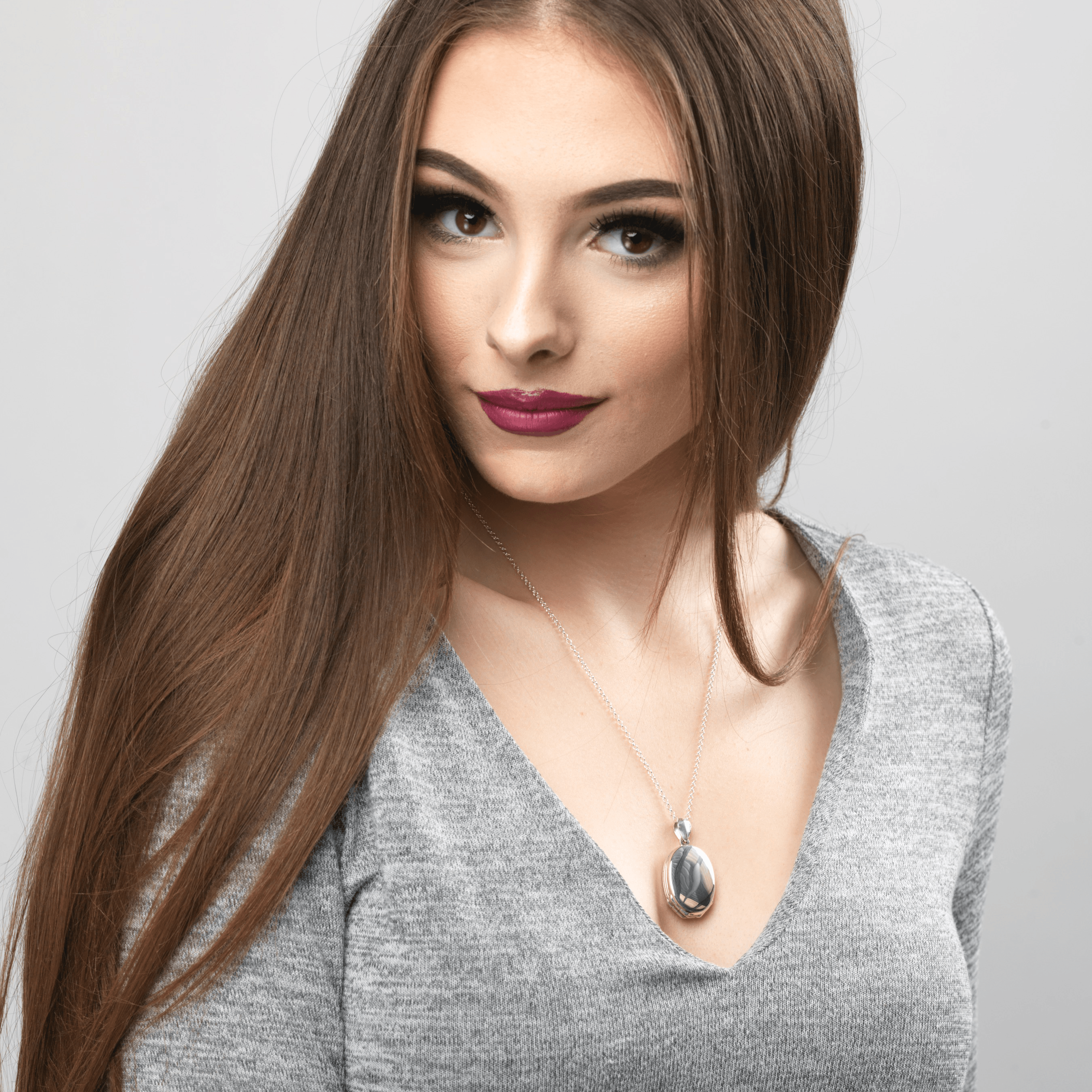 model wearing a 4-photo sterling silver oval locket on a sterling silver chain