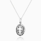 sterling silver oval locket with a cross surrounded by filigree, on a sterling silver rope chain