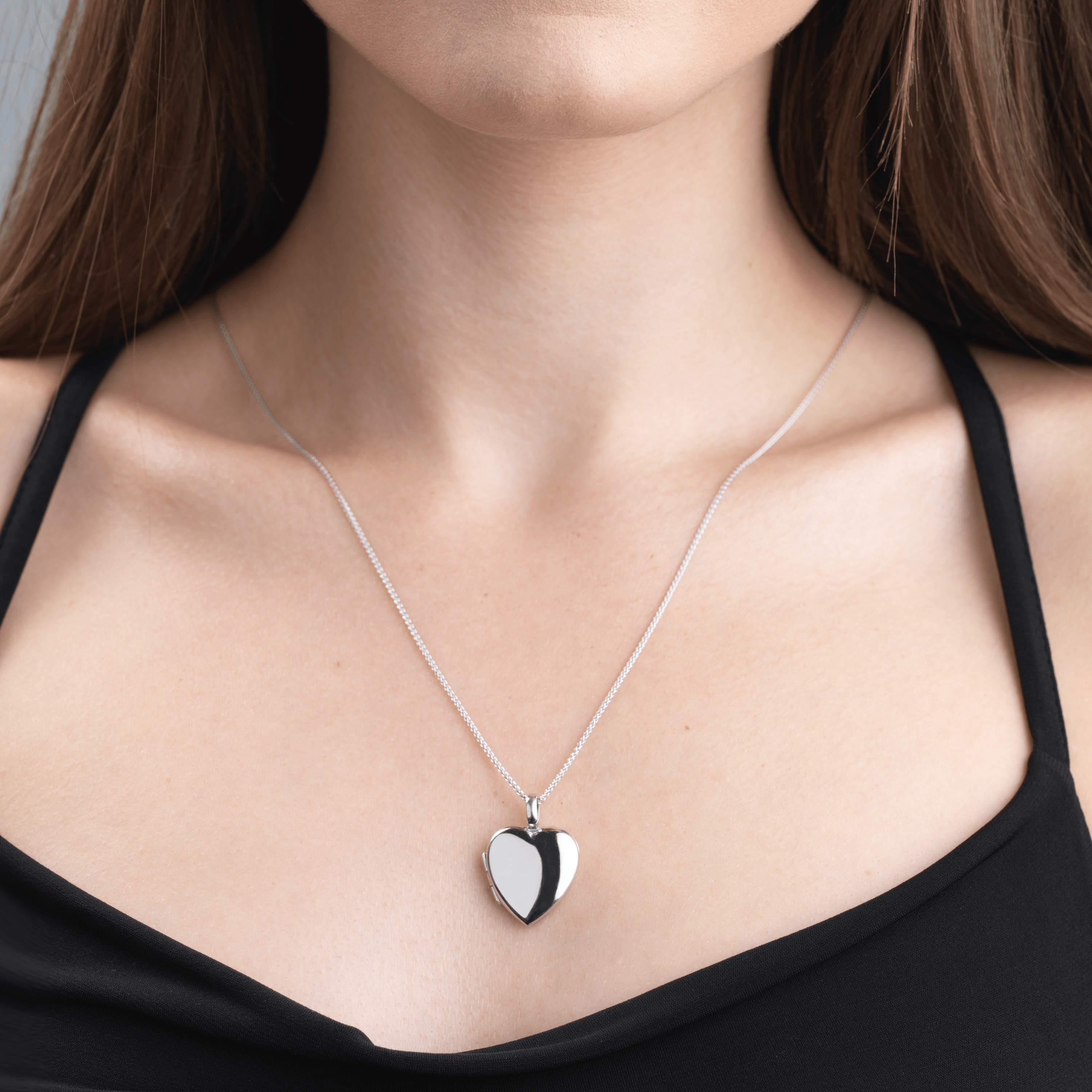 Model wearing an 18 ct white gold heart locket on an 18 ct white gold spiga chain
