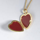 Open view of an 18 ct gold heart locket on an 18 ct gold spiga chain