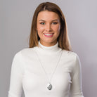 model wearing a Large oval sterling silver 4-photo locket on sterling silver chain