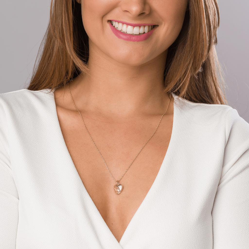 model wearing a petite 9 ct gold floral engraved locket on a 9 ct gold rope chain